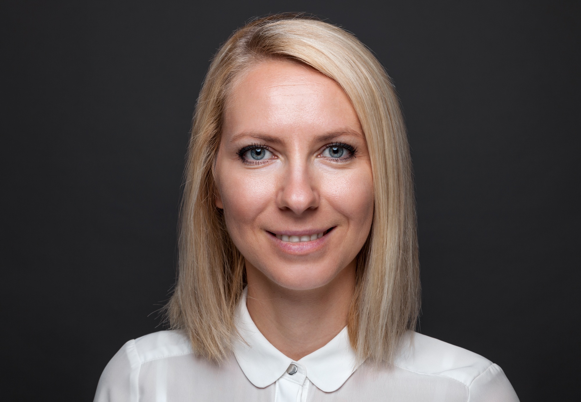 Headshot of young and happy business woman